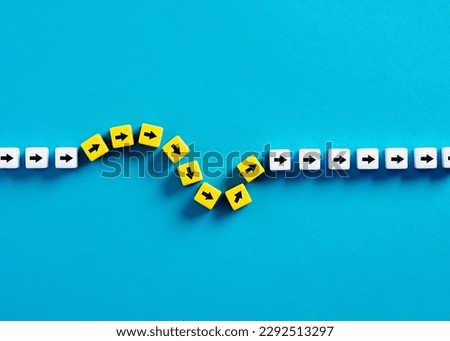 Flexibility and adaptation concept. Arrows on cubes following a flexible path. Royalty-Free Stock Photo #2292513297