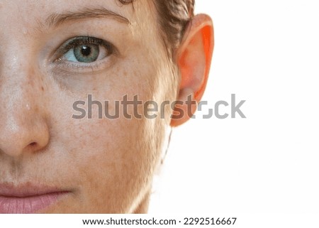 Naturally strong portrait half-sided of a woman without make-up with sun spots on her face Royalty-Free Stock Photo #2292516667
