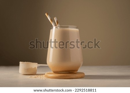 Healthy chocolate protein shake drink with straw, and protein powder Royalty-Free Stock Photo #2292518811