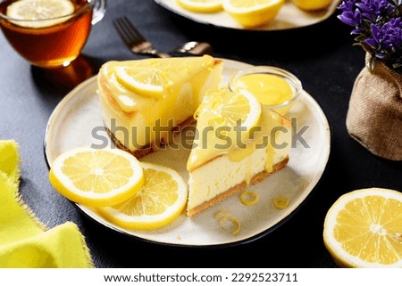 Fresh baked homemade lemon cheesecake with lemon curd and lemon slices. Royalty-Free Stock Photo #2292523711
