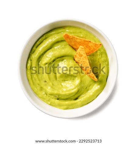 Avocado dip sauce guacamole with tortilla corn nachos chips in a white bowl . Isolated on white background. Top view. Royalty-Free Stock Photo #2292523713
