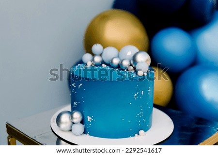 Festive blue cake with balloons design