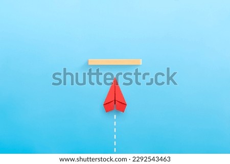 Concept of overcoming barriers, goal, target. Red paper plane Royalty-Free Stock Photo #2292543463