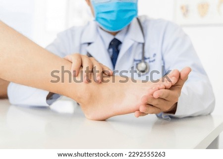 The orthopedic doctor or surgeon in white gown examined the patient with foot pain problem.White clean table or bed with blur background.Hallux or bunion with transfer metatarsalgia.Orthopaedic unit. Royalty-Free Stock Photo #2292555263