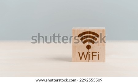 Wifi icon on wooden cube block for service in the cafe. Business communication social network with wi-fi, Wireless network and connection technology concept. Royalty-Free Stock Photo #2292555509