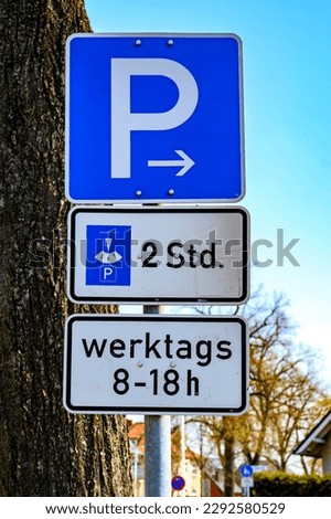 Parking lot sign with additional notes on a limited park duration of two hours at weekdays between 8 and 18 o'clock.