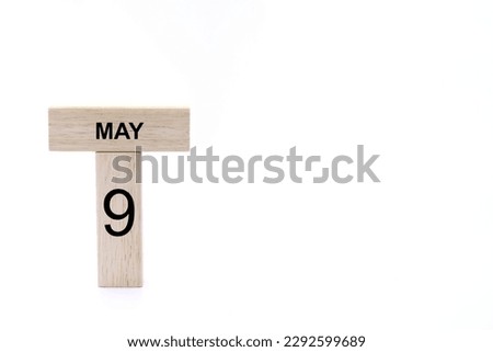 May 9 displayed wooden letter blocks on white background with space for print. Concept for calendar, reminder, date. 