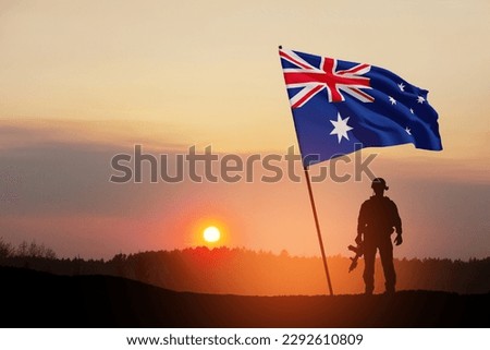 Silhouette of soldier with Australia flag on background of the sunset or the sunrise background. Anzac Day. Remembrance Day. Royalty-Free Stock Photo #2292610809
