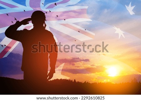 Silhouette of soldier saluting on background of Australia flag and the sunset or the sunrise background. Anzac Day. Remembrance Day. Royalty-Free Stock Photo #2292610825