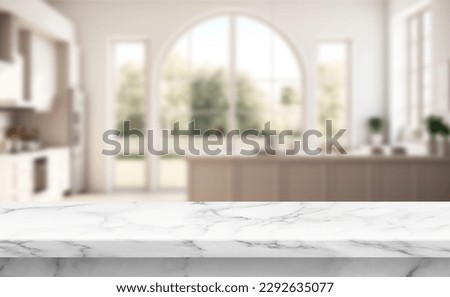 Close up photo of contemporary kitchen island with marble table top with kitchen blurry loose focal of a giant arch windows background