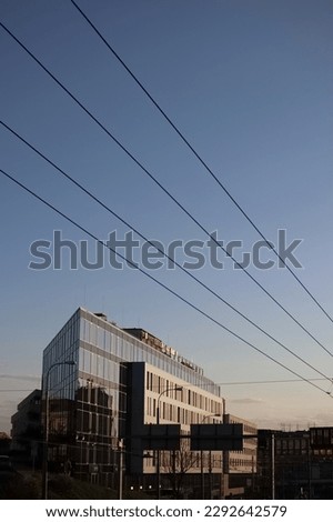 Acute-angled building with glass and white facade. Royalty-Free Stock Photo #2292642579