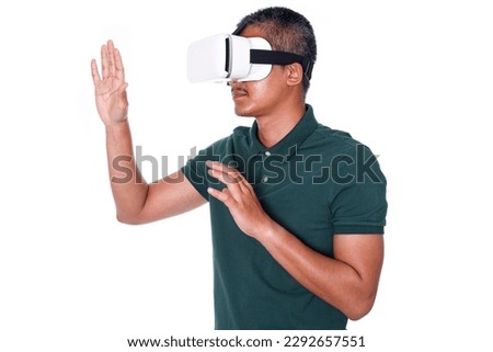 Man wearing virtual reality headset isolated on white background.  trying to touch something with hand