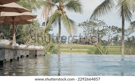sun lounger by the pool on the terrace next to the pool. The concept of tropical relaxation, relaxation,4k