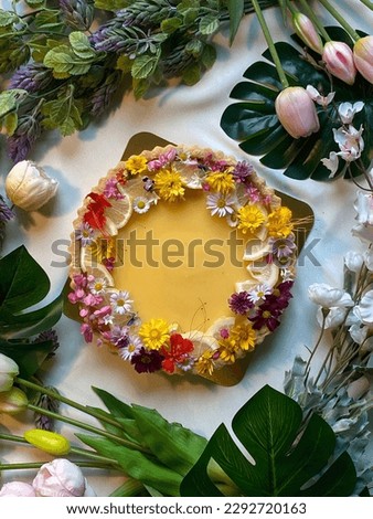 A lemon tart (tarte au citron) is a dessert made with a shortcrust pastry base and a filling of lemon curd. Decorate with colorful edible flowers. Makes this pic looks like a dessert in the garden