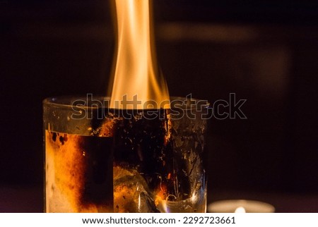 The flame of a burning candle, the candle burns with a yellow flame, fire, the concept is a wax candle in a glass beaker