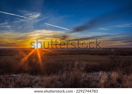 Texas sunset over a field Royalty-Free Stock Photo #2292744783