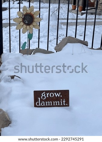 “Grow dammit” garden sign in snow