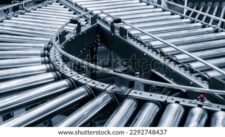 Crossing of the roller conveyor, Production line conveyor roller transportation objects Royalty-Free Stock Photo #2292748437