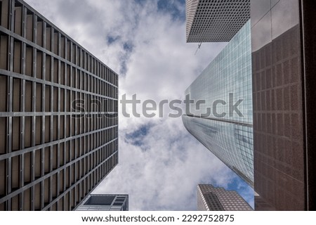 Looking up towards the sky between skyscrapers in Houston Texas.