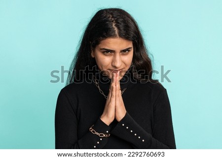 Sneaky cunning indian arabian woman with tricky face gesticulating, scheming evil plan, thinking over devious villain idea, cunning cheats, jokes, pranks. Hindu girl isolated on studio blue background Royalty-Free Stock Photo #2292760693