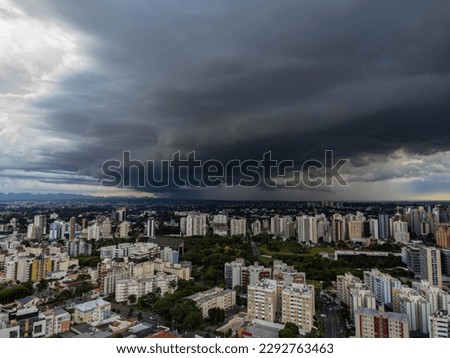 Aerial photo showing a storm approaching the city, with very dark clouds