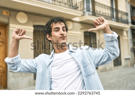 Young handsome caucasian man at outdoor feels proud and self confident, example to follow. Royalty-Free Stock Photo #2292763745