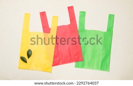 Biodegradable bags on concrete background, top view