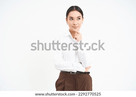 Thoughtful businesswoman, looks aside and thinks, plans smth, stands over white background.