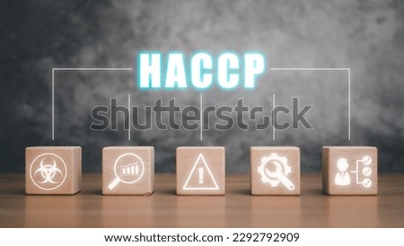 HACCP, Hazard Analysis and Critical Control Points concept, Wooden block on desk with HACCP icon on virtual screen.