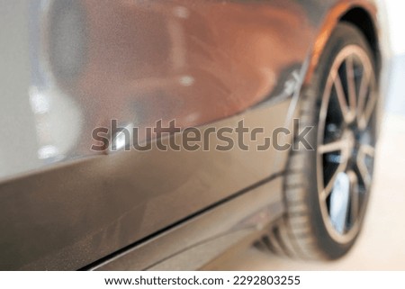 Car dent after traffic accident or crash.Deformity lesion on the rear door of grey vehicle with space.Rear wheel with blur background and space.Insurance prompt to repair the car dent.Small dent. Royalty-Free Stock Photo #2292803255