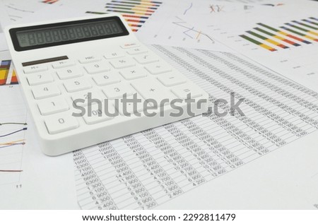 Wide angle image of calculator on financial documents.