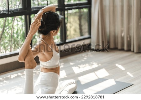 Female happiness Attractive young asian woman doing yoga stretching exercise on mat yoga fitness exercises. Healthy lifestyle Calmness and relax at home