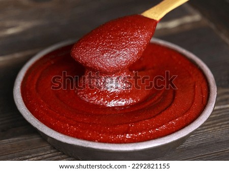 Close-up and top angle view of red pepper paste with spatula on a jar and wood floor, South Korea
 Royalty-Free Stock Photo #2292821155