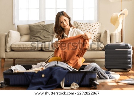 Portrait of backpacker beauty asian traveler woman packing prepare stuff and outfit clothes in suitcases travel bag luggage for summer, holiday, weekend, tourist, journey, vacation trip at home.travel Royalty-Free Stock Photo #2292822867