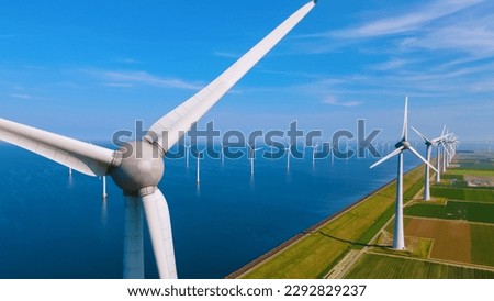 Windmill Park with a blue sky and green agricultural field, and windmill turbines park in the ocean. Netherlands Europe the biggest wind park in the Netherlands Royalty-Free Stock Photo #2292829237