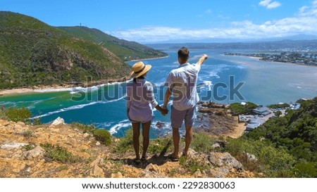 A panoramic view of the lagoon of Knysna, South Africa. beach in Knysna, Western Cape, South Africa. A couple of man and woman on a trip at the garden route in South Africa Royalty-Free Stock Photo #2292830063