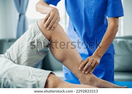 Male Doctor and patient suffering from back pain during medical exam. in clinic
