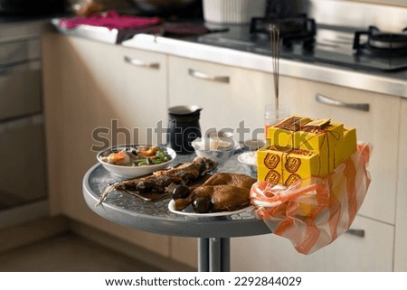 During the Chinese New Year, a table of offerings was placed in the kitchen to worship the gods.(The words on the yellow paper mean: joss paper) Royalty-Free Stock Photo #2292844029
