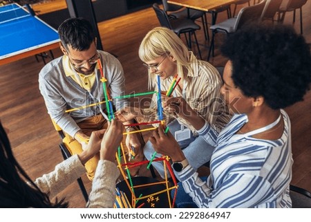 Team building activities in the office with sticks.Concept of friendship, teambuilding and teamwork.  Royalty-Free Stock Photo #2292864947