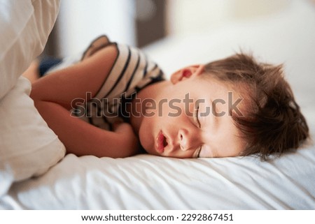 Picture of a tired young boy sleep on holidays