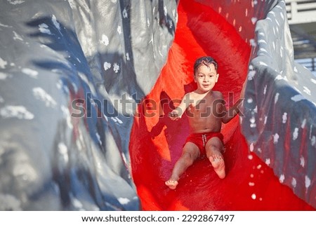 Picture of young boy playing in outdoor aqua park