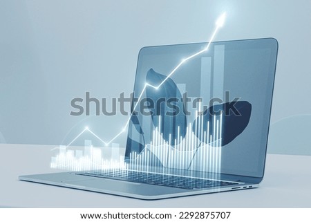 Close up of laptop with growing business chart on blurry background. Business strategy development, financial growth and success plan. Double exposure