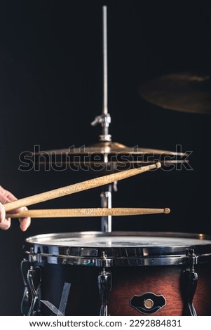 Snare drum and cymbals on a black background.