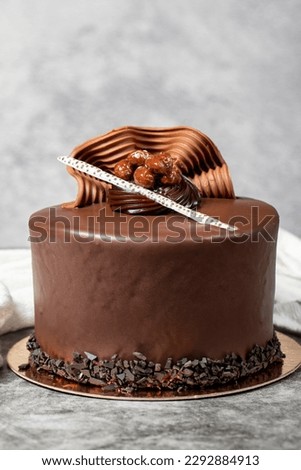 Chocolate cream cake. Chocolate birthday cake on dark background. patisserie desserts. Close up Royalty-Free Stock Photo #2292884913