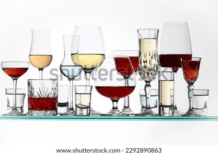 Various alcoholic drinks in the bar on glass shelves.