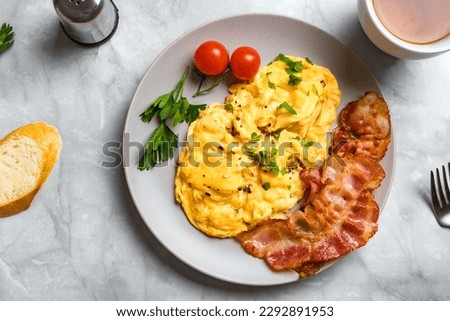 Scrambled Eggs and Bacon for breakfast, top view. Keto food, healthy breakfast with scrambled egg. Royalty-Free Stock Photo #2292891953