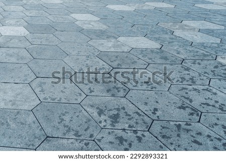 The texture of a monotonous hexagonal tiled pavement with perspective.