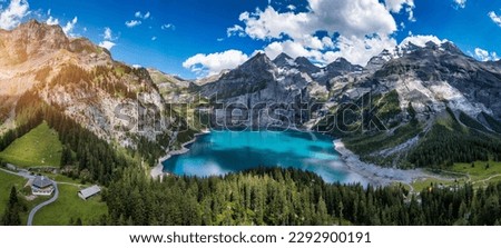Famous Oeschinensee with Bluemlisalp mountain on a sunny summer day. Panorama of the azure lake Oeschinensee. Swiss alps, Kandersteg. Amazing tourquise Oeschinnensee with waterfalls, Switzerland. Royalty-Free Stock Photo #2292900191