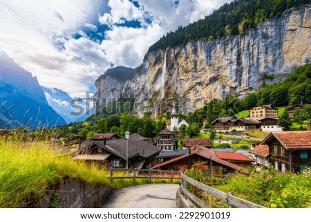 Lauterbrunnen valley with famous church and Staubbach waterfall. Lauterbrunnen village, Berner Oberland, Switzerland, Europe. Spectacular view of Lauterbrunnen valley in a sunny day, Switzerland. Royalty-Free Stock Photo #2292901019
