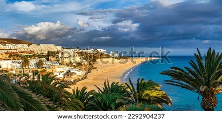 Morro Jable, Fuerteventura, Spain. Breathtaking beach Playa del Matorral in the rays of the sunset. Morro Jable and Playa del Matorral, Fuerteventura, Canary Islands, Spain, Atlantic, Europe Royalty-Free Stock Photo #2292904237